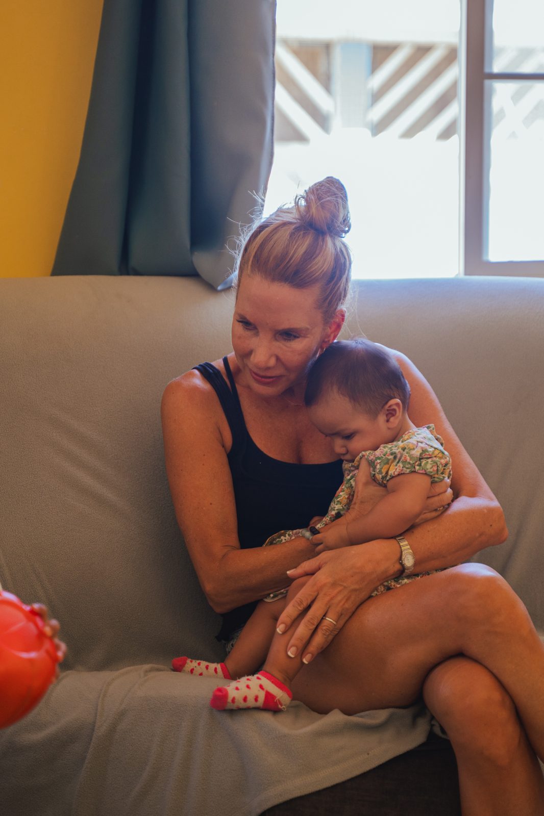 Volunteer holding a baby during a visit to Rancho de los Niños
