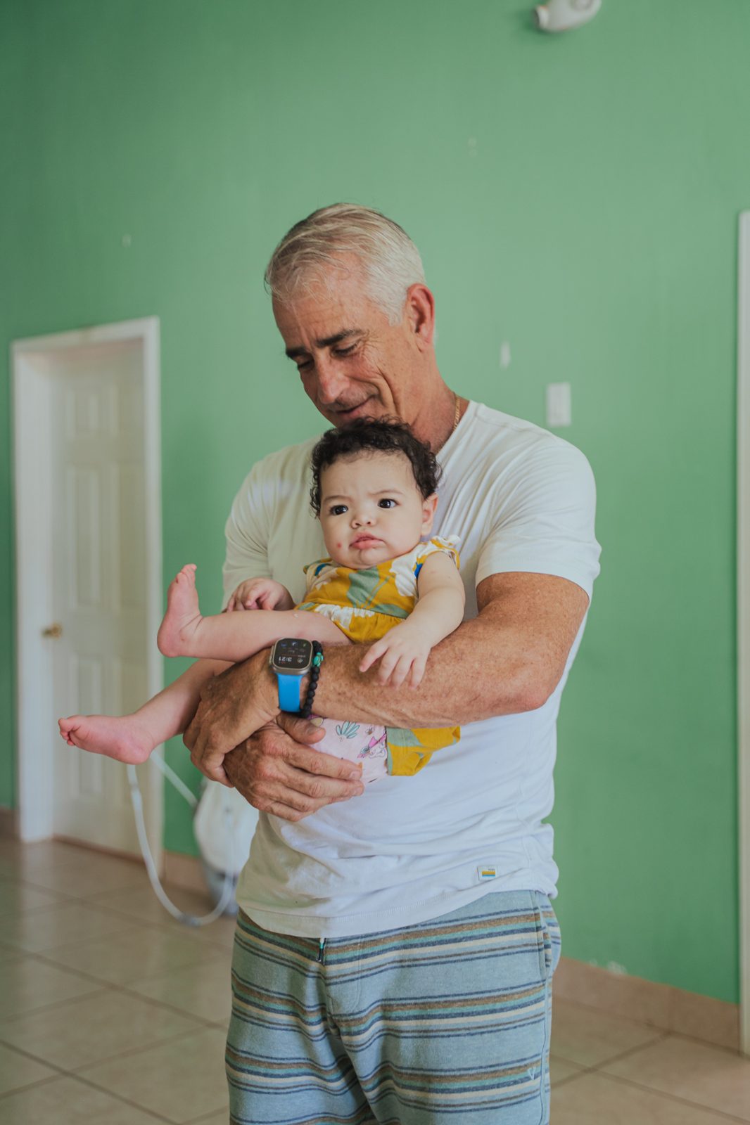 Volunteer holding a baby at Rancho de los Niños