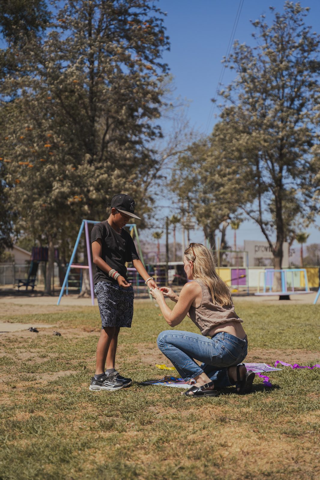 Volunteer helping a child with a kite