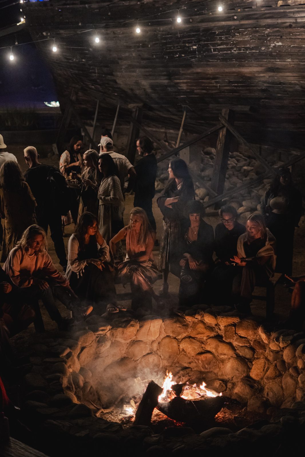 Community gathered around a fire at night
