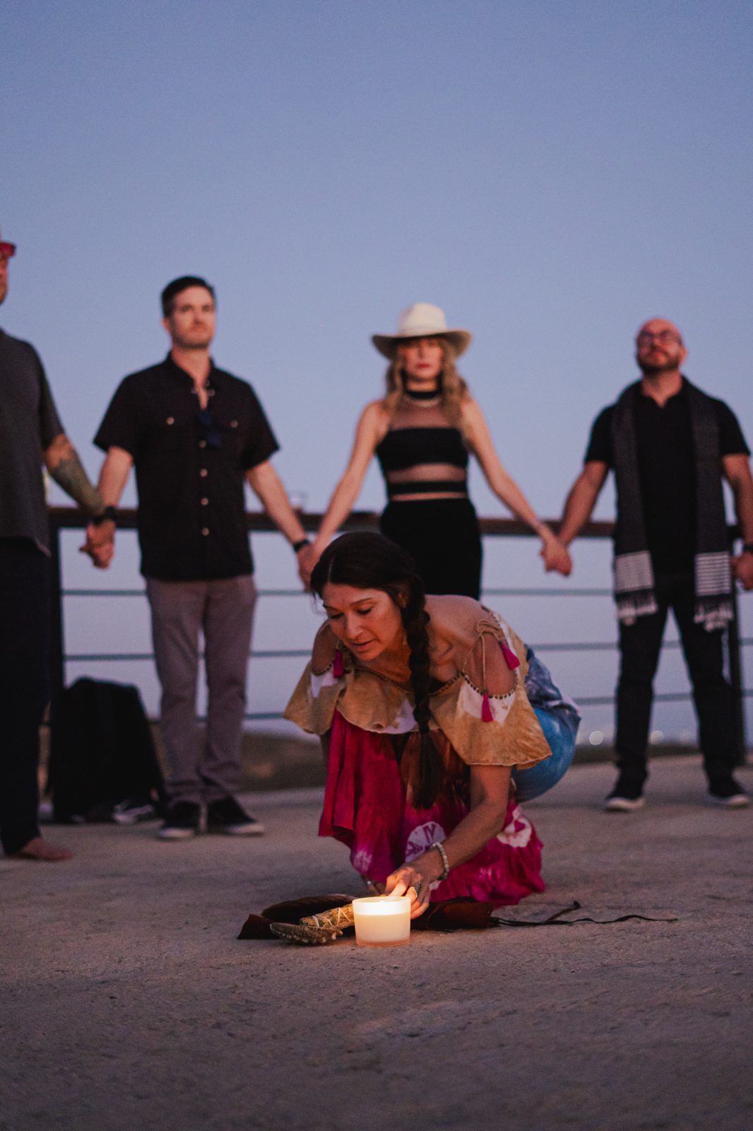 Opening ceremony with a candle and a circle of hands